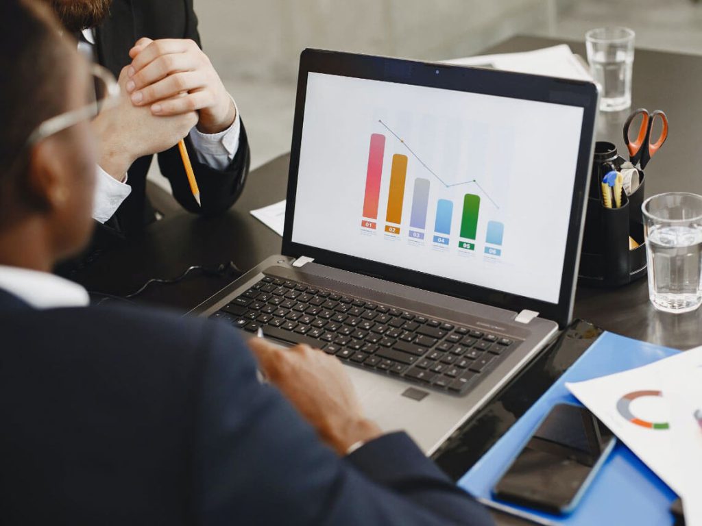 Reviewing VAT reports and system setup on a laptop